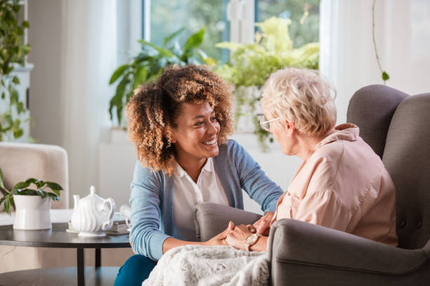 Caregiver helping elderly woman